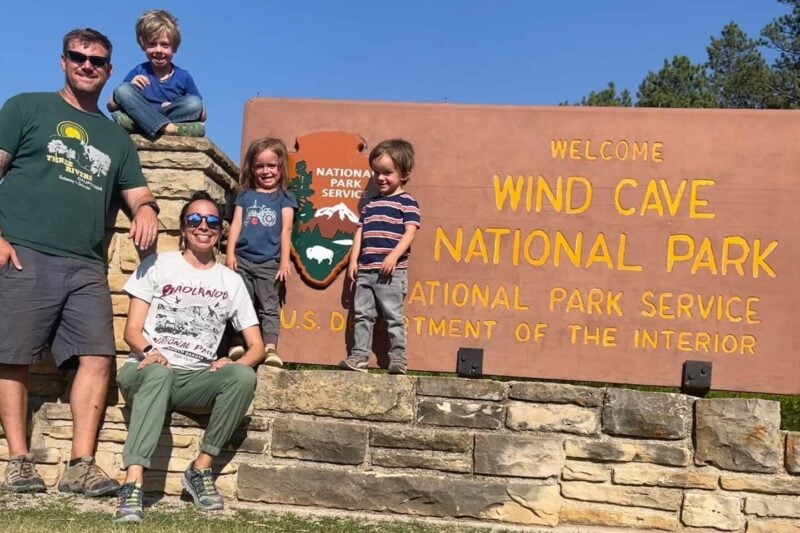 The author and her family stand in front of a sign for Wind Cave National Park