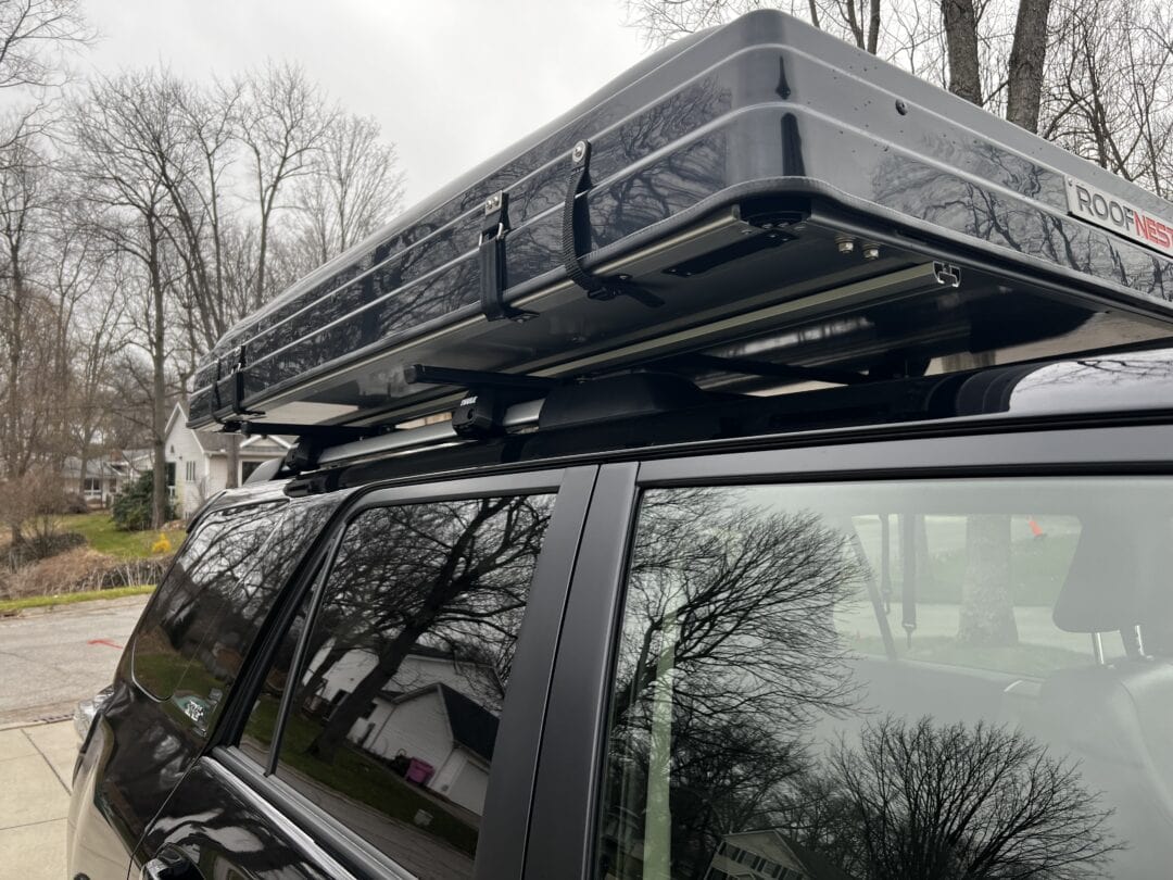 Black 4Runner with a roof rack system and rooftop tent on the roof