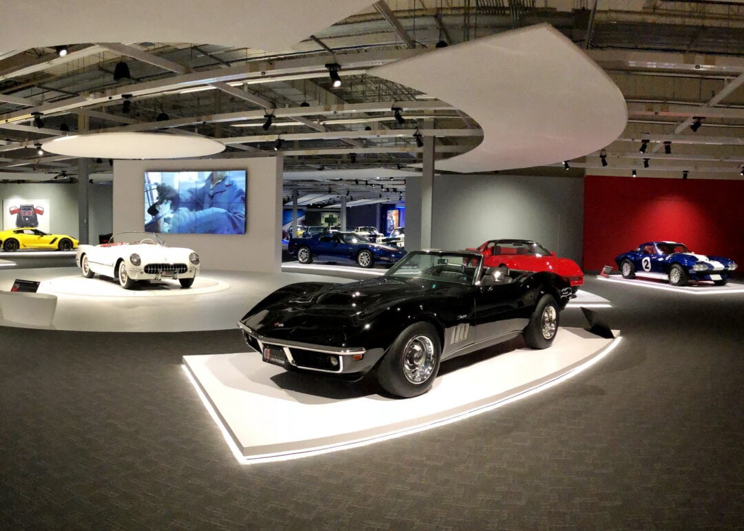 a car museum showroom with various classic corvettes
