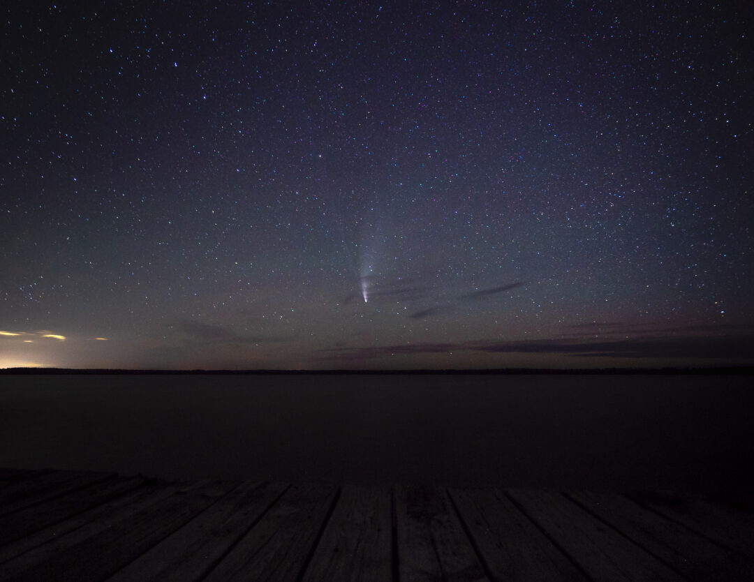 Comet shooting through the dark night sky