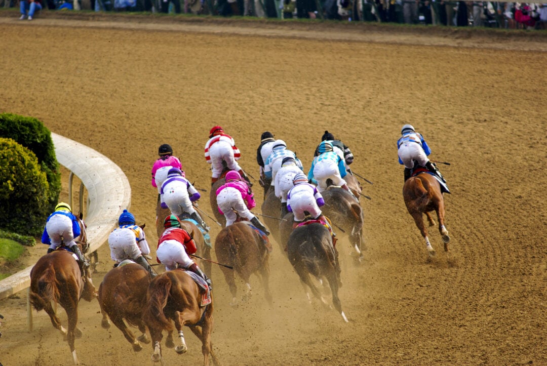 Horses race along the track at Churchill Downs
