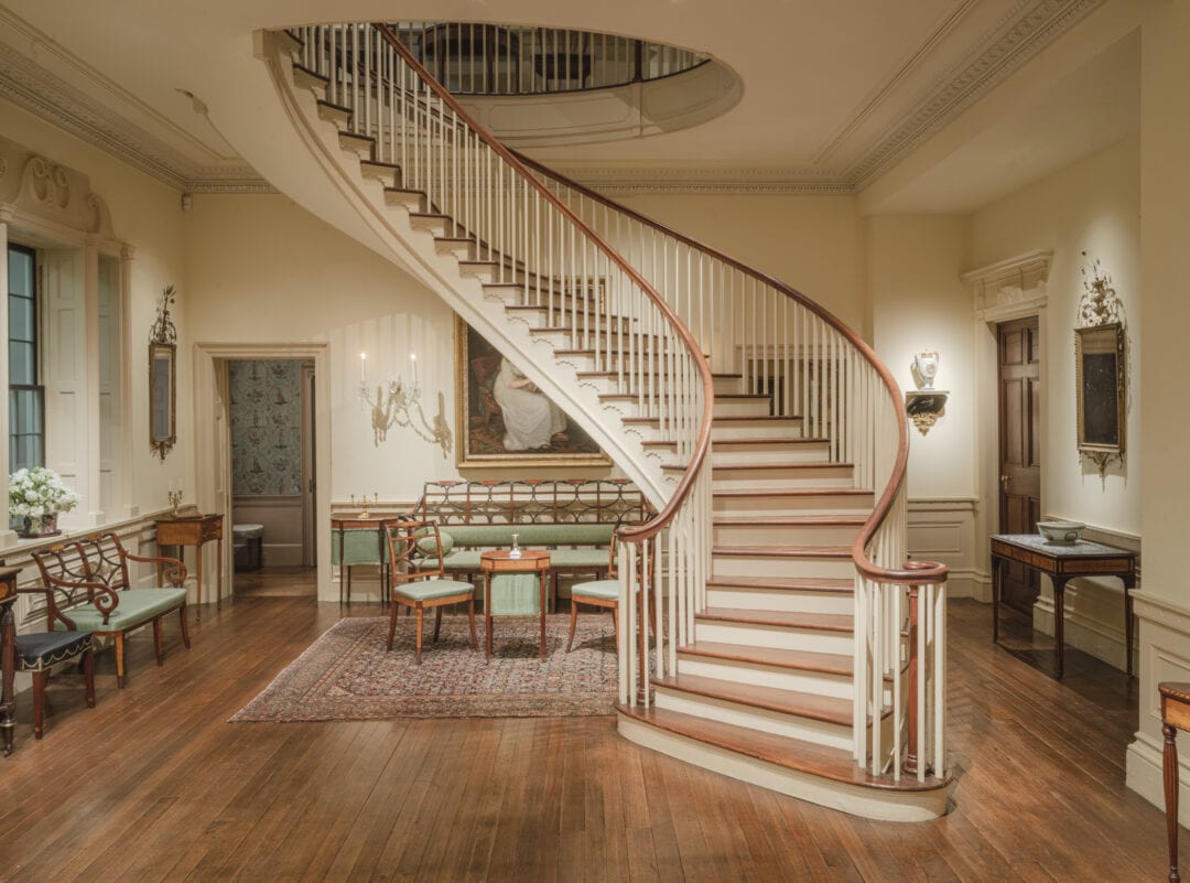 An ornate winding staircase greets visitors at Winterthur Museum, Garden and Library