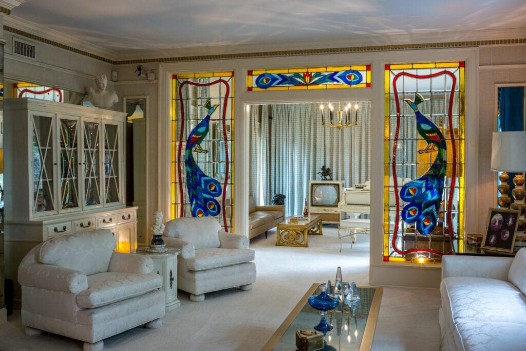 The inside of a room at Elvis' Graceland mansion features large stained glass windows