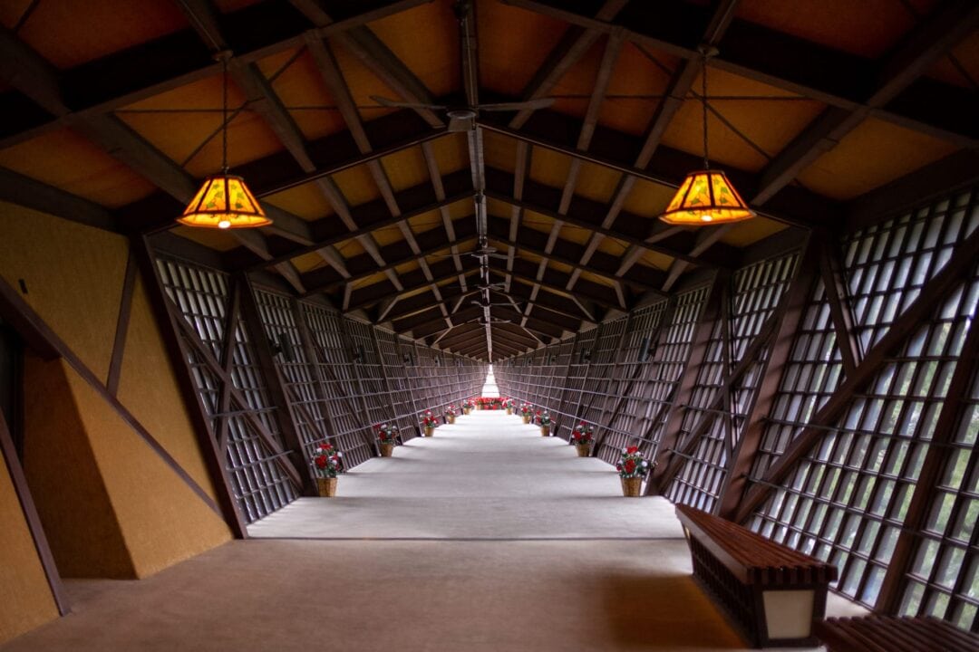 Long walkway inside of the House on the Rock with a unique wooden design of ceiling beams and walls
