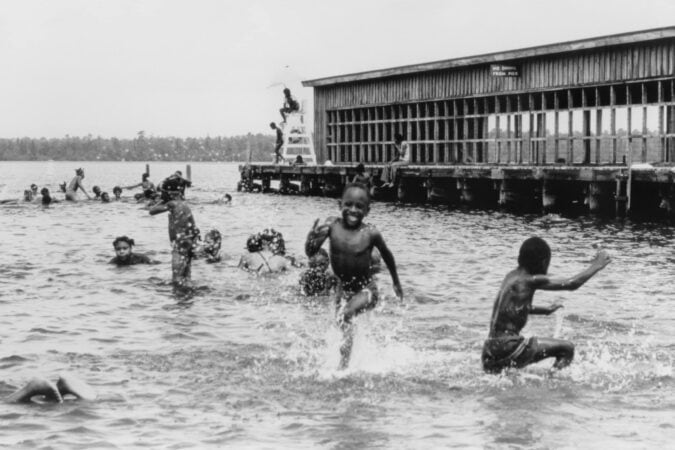 A black-and-white historical photo of people swimming at Jones Lake State Park