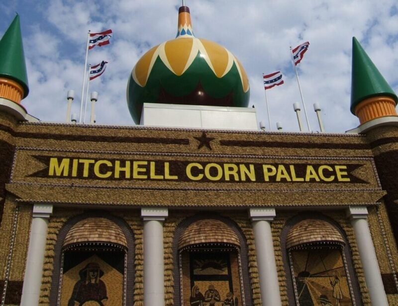 Large palace-like building with corn murals and decor covering the exterior