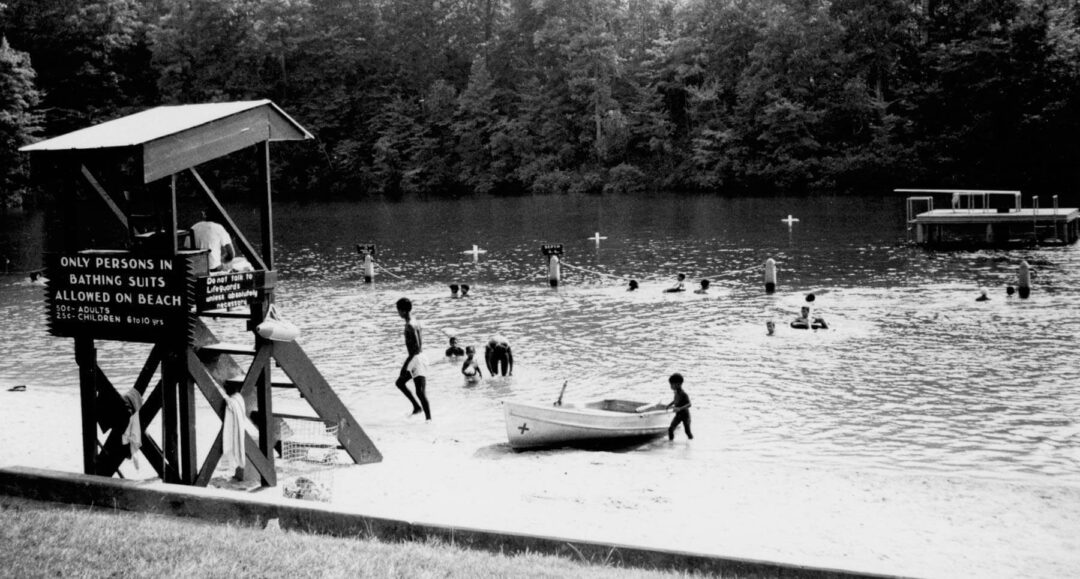 A black-and-white photo of a swimming and boating area