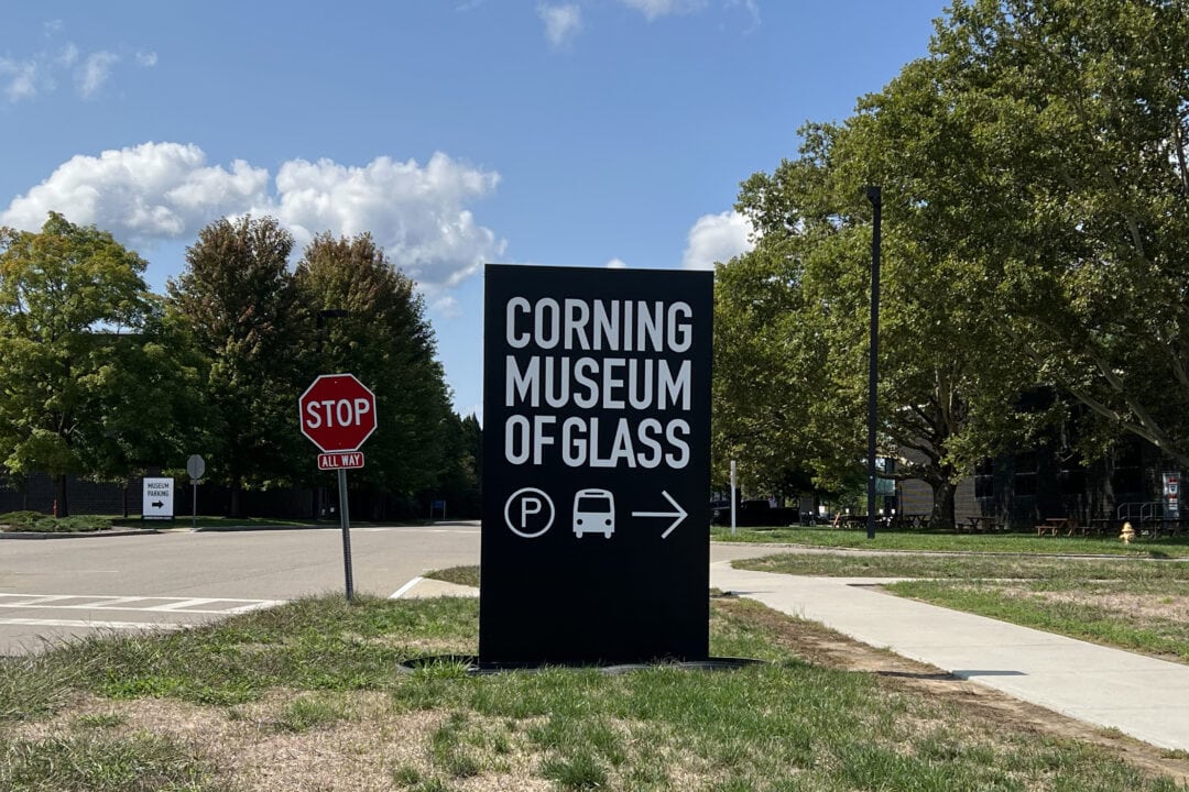 a black and white sign for the corning museum of glass