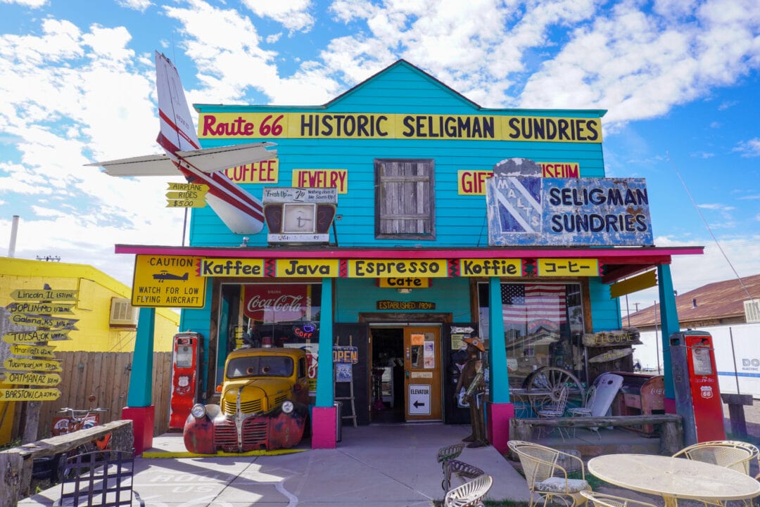A quirky, colorful building stands as the storefront for Historic Seligman Sundries