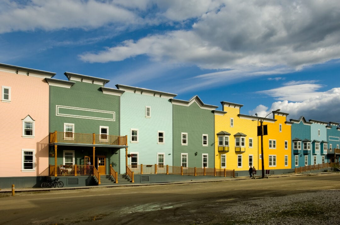 A row of multi-colored buildings welcomes visitors to Dawson