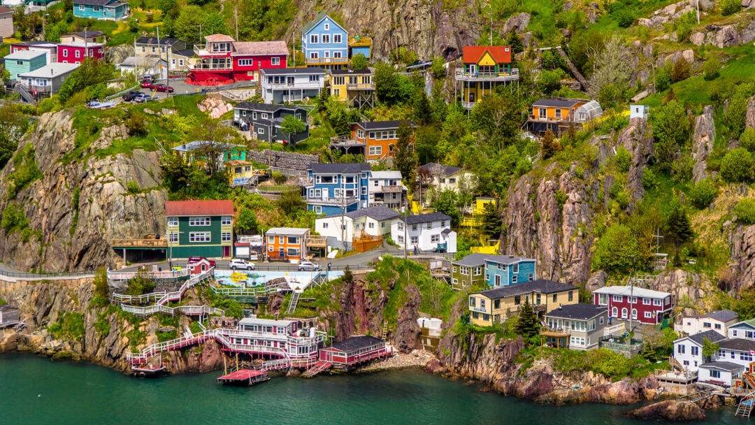 Colorful homes sit on climbing ledges along the coastline in St. John's