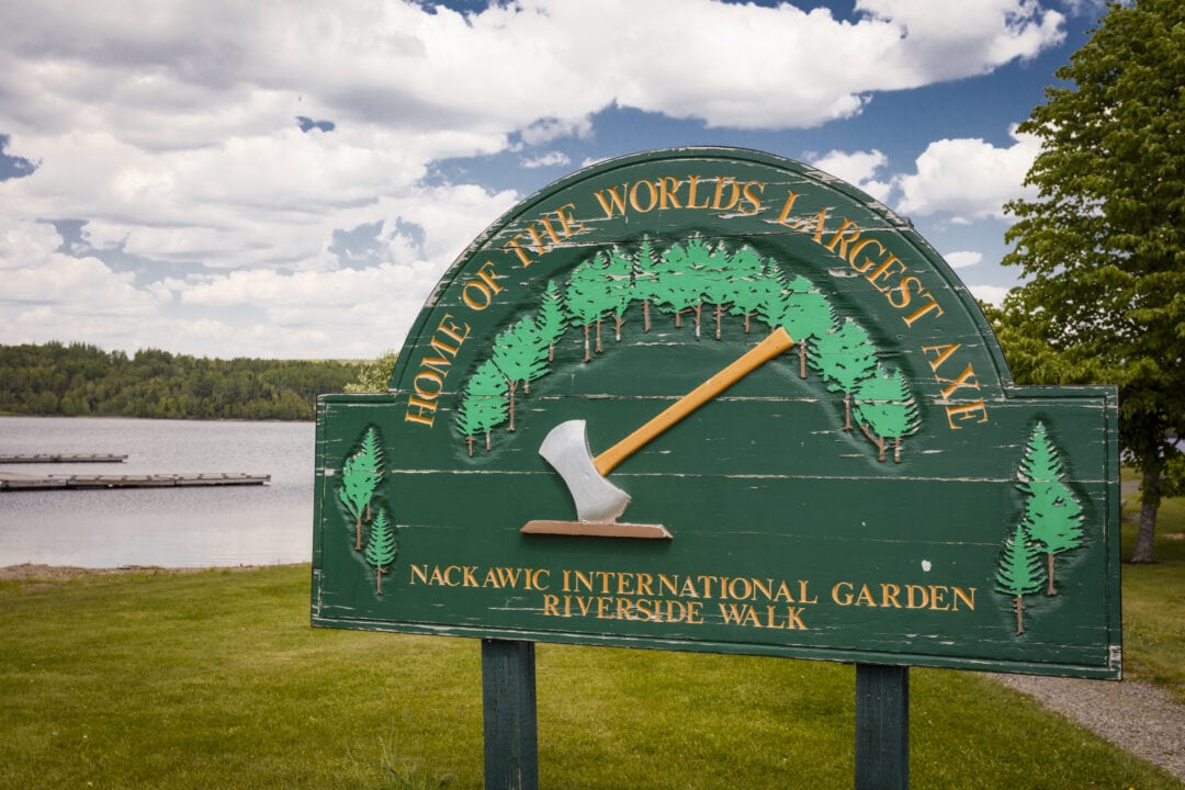 A rugged, wooden sign depicting an axe reads: Home of the world's largest axe 