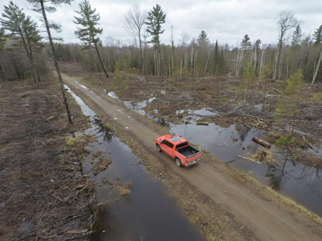 A 2023 Toyota Tundra TRD Pro iFORCE MAX travels over a rugged, wet and muddy landscape
