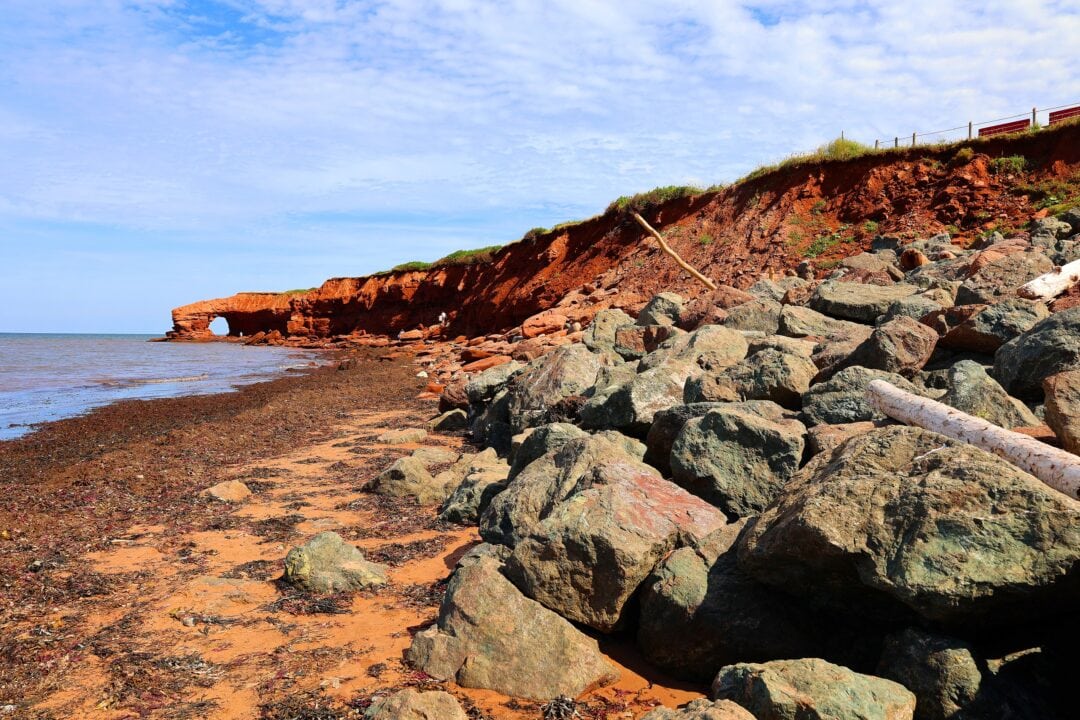 Rocky shoreline with red rock formations