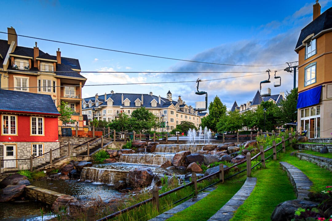Colorful village of Mont Tremblant during the summer with water feature and gondola ride