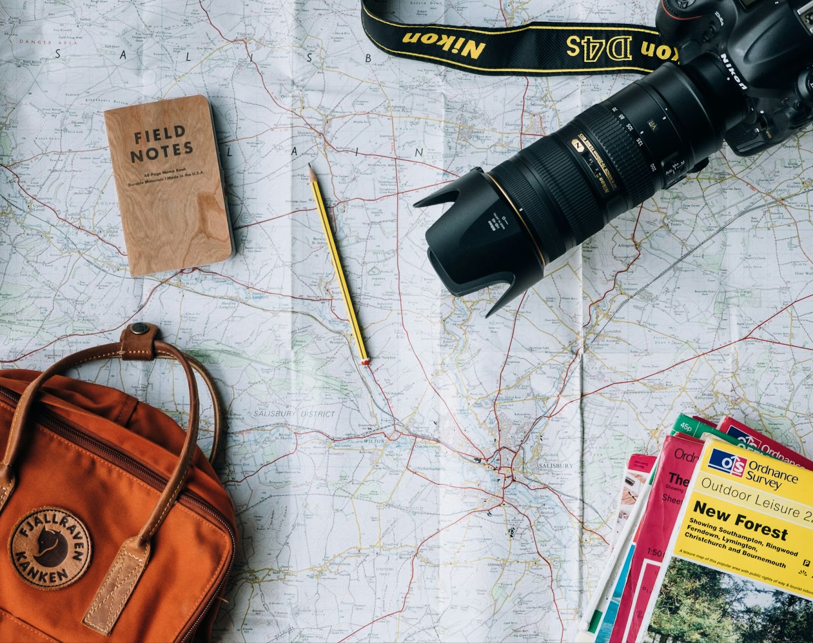 Camera and guidebooks over map