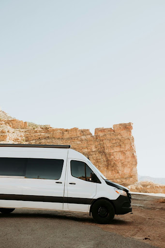 Van with a rock behind it