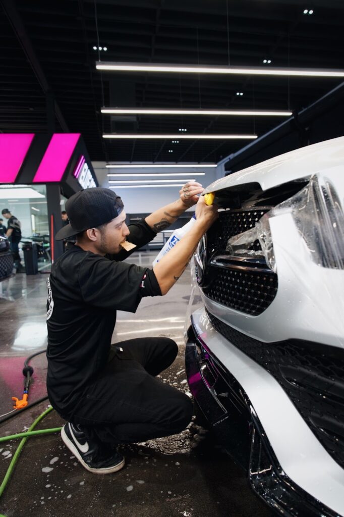 Paint Protection Film being added to the front bumper of a car